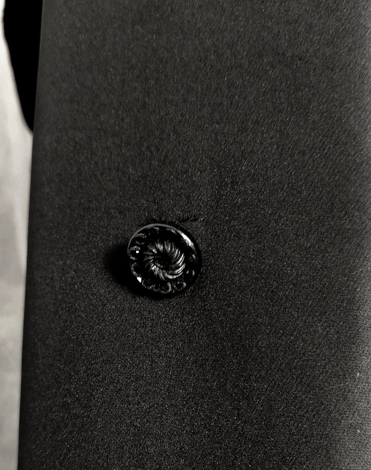 Close-up of black vintage button with black rhinestones.