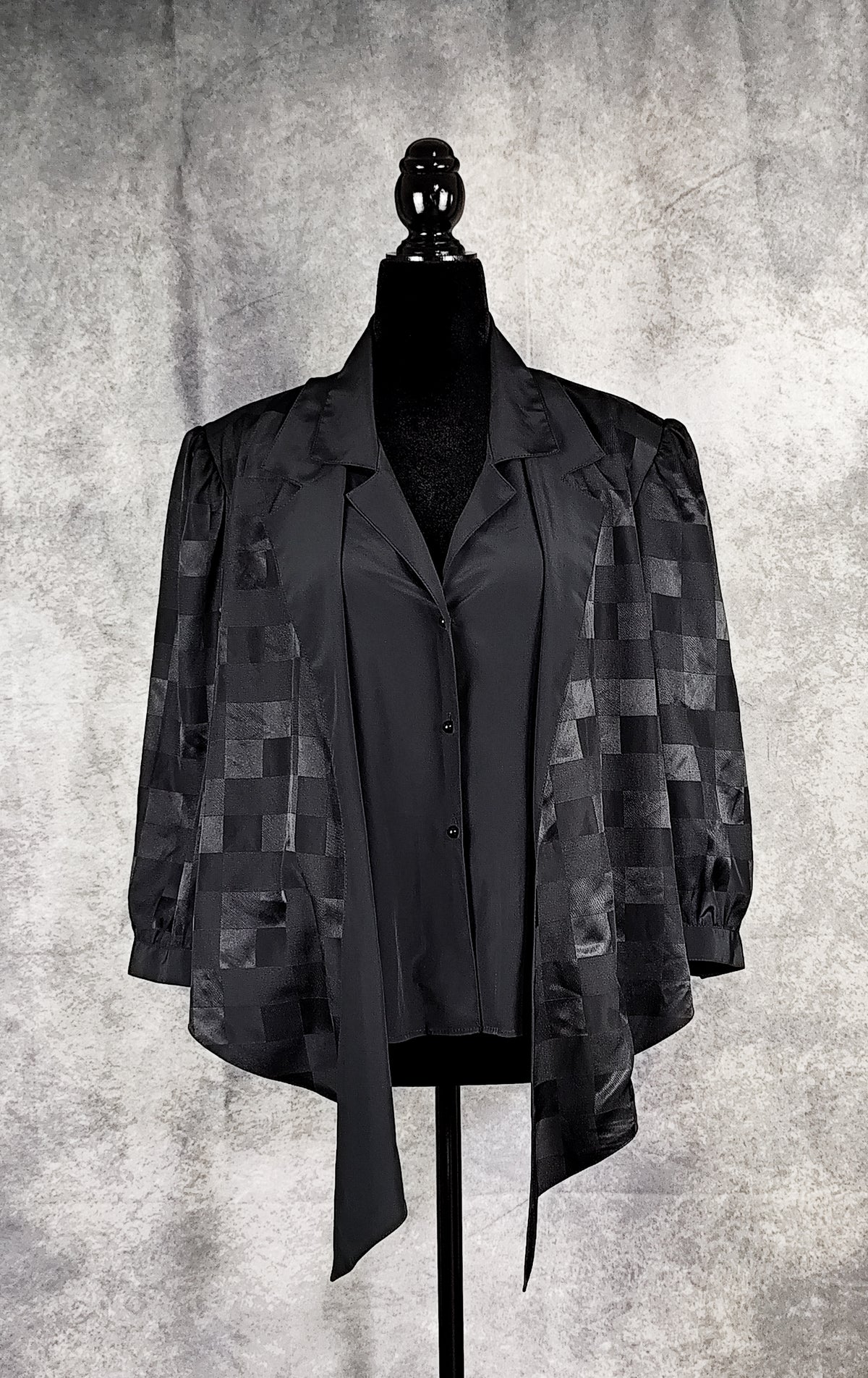 Front view of a black patterned blouse from the 90's with a checkered design, for sale at Faceless Queen store. 
