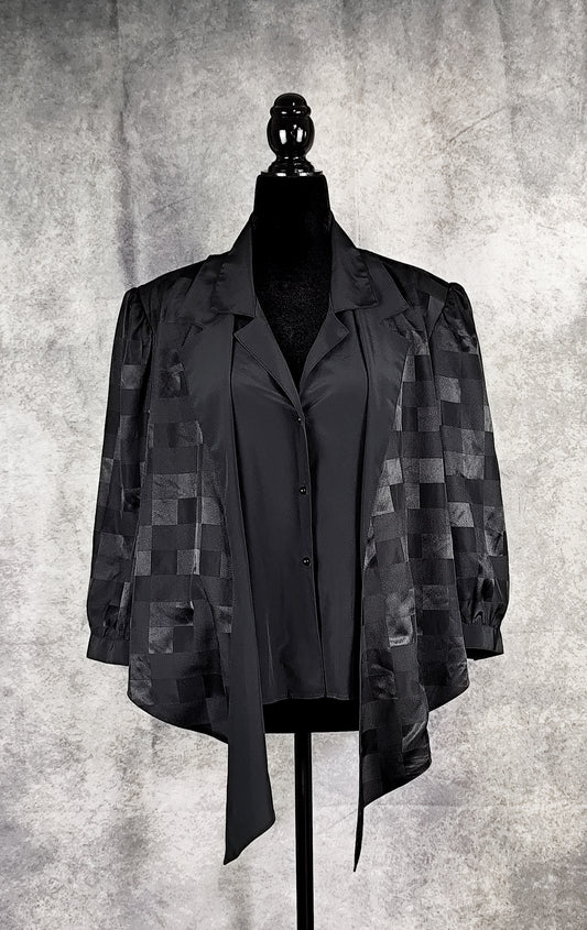 Front view of a black patterned blouse from the 90's with a checkered design, for sale at Faceless Queen store. 