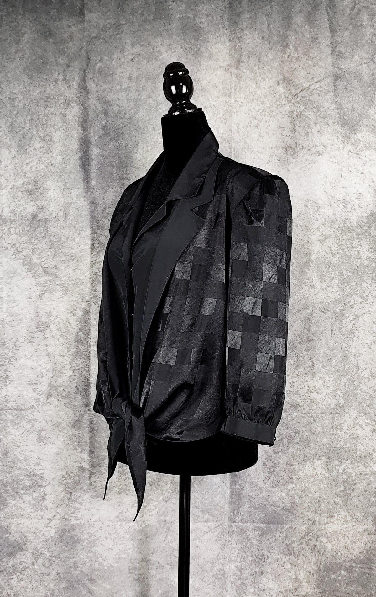 Side view of a black patterned sheer blouse from the 90's with a checkered design, for sale at Faceless Queen store. 