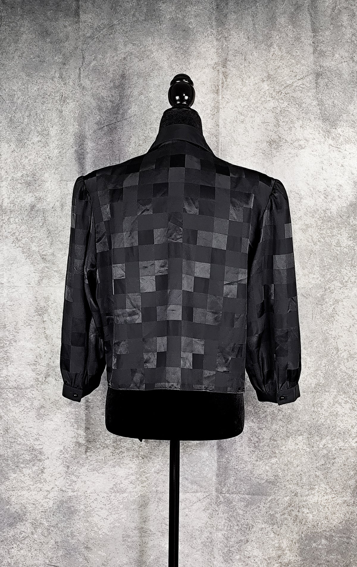 Back view of a black patterned sheer blouse from the 90's with a checkered design, for sale at Faceless Queen store. 