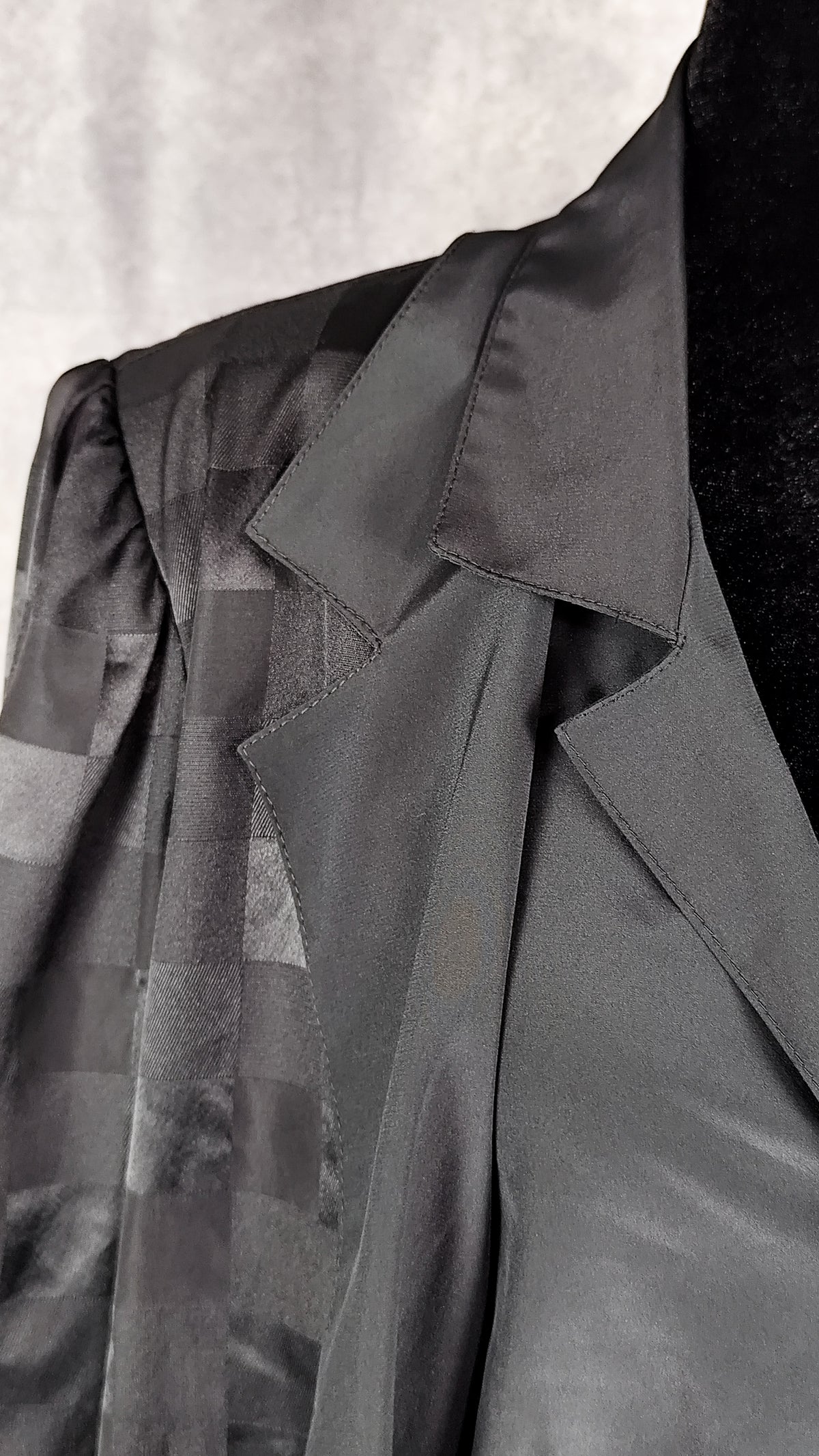 Close-up of the collar of a black patterned sheer blouse from the 90's with a checkered design, for sale at Faceless Queen store. 