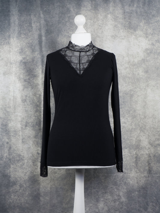 Front view of a black Long sleeve top with lace collar and lace cuffs. Gothic aesthetic.