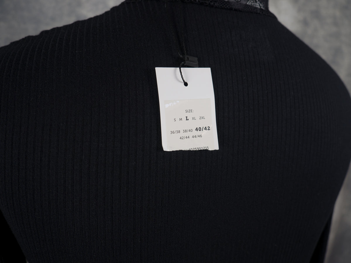Close-up of a tag from a long-sleeve ribbed knit black top
