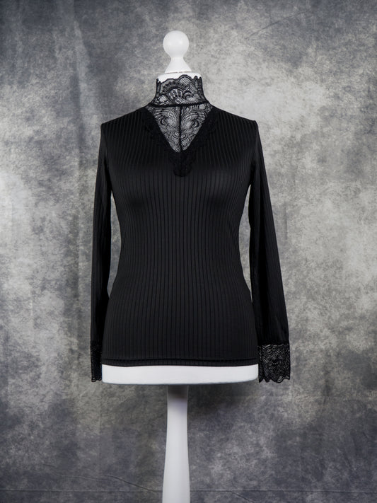 A black long-sleeve ribbed knit top with a lace mock neck and lace cuffs, displayed on a white mannequin torso against a textured gray studio backdrop.