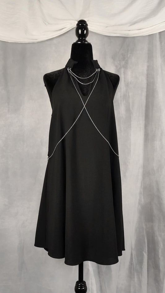 Front view of black tunic with removable chains on the collar and chest.