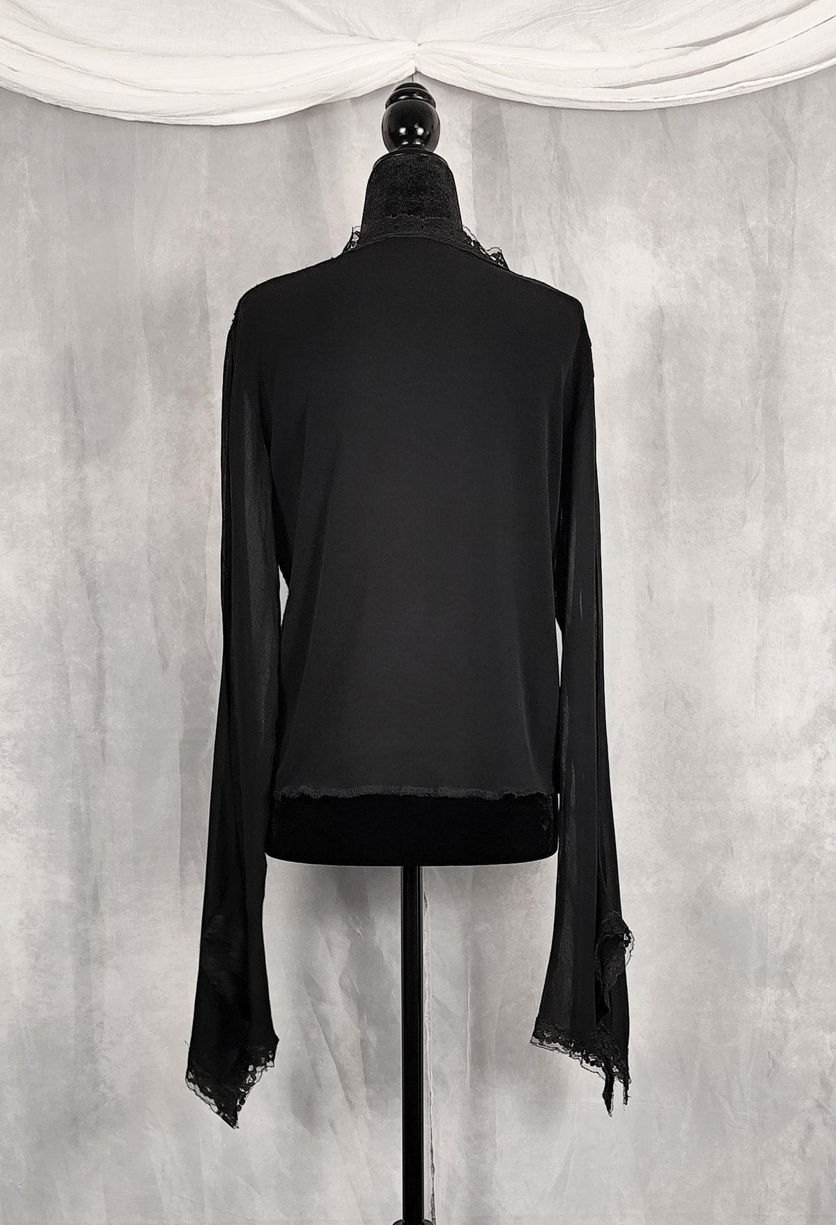 Back view of a black long-sleeve lace-trim cardigan for sale by Faceless Queen. 