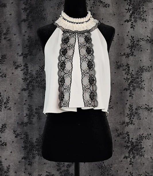 Front view of a Zara white sleeveless blouse transformed by Faceless Queen with black lace trim and a ruffled high neck.