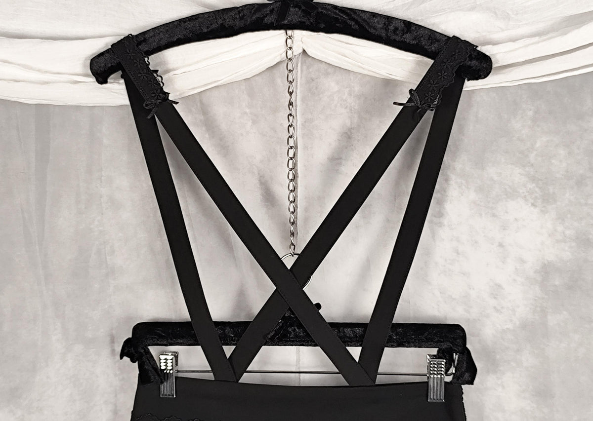 Straps detail trimmed with lace and satin bows.